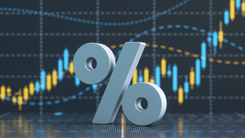Per cent symbol on a blurred background of stock exchange market trading graph